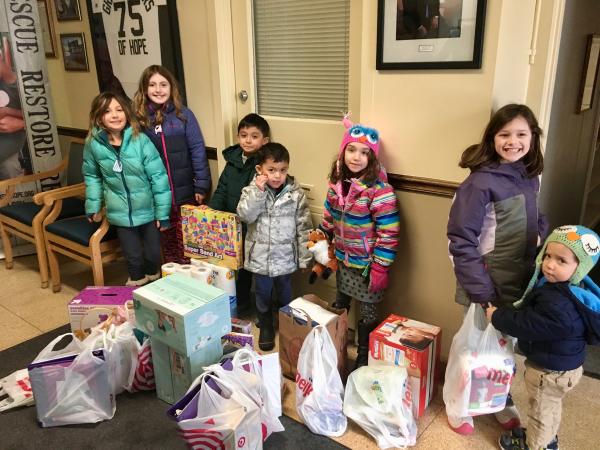 Four families from the children's class that meets weekly in Troy deliver donations to the Grace Centers of Hope in Pontiac, Michigan, in February, 2019. Classes for children 5-11 have been meeting in Troy for 6 years.